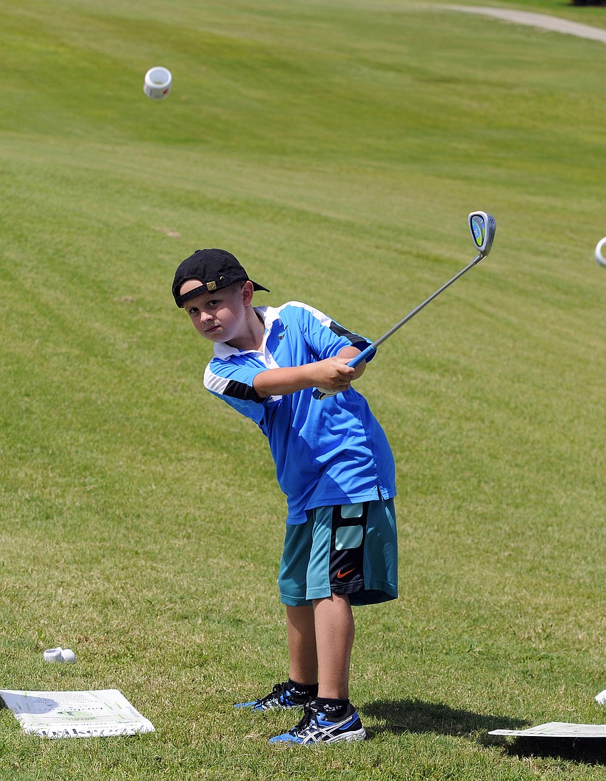 Matthew Almeida, 8, works on a pitching drill.