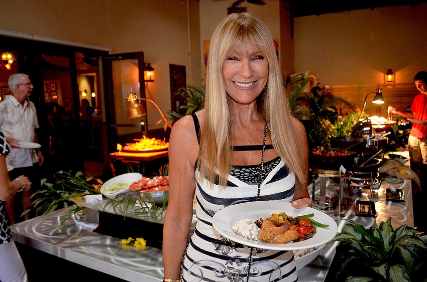 Lynn Barrie fills her plate with Louisiana-themed cuisine.