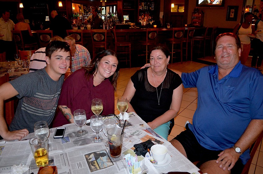 Trevor Davis and the Donovan family — Trish, Jane and Jim — tap their feet to the live music.