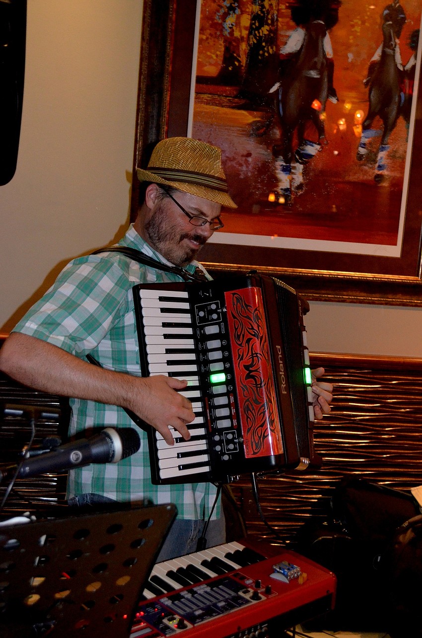 Ryan Langley plays the accordion for attendees.