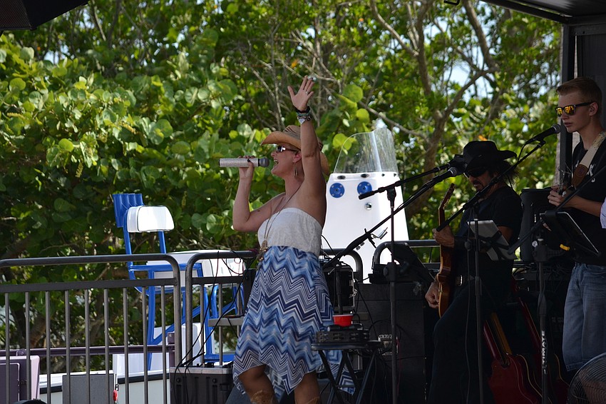 Kim Betts sings along with the Gamble Creek Band Friday evening at the Van Wezel Performing Arts Hall.