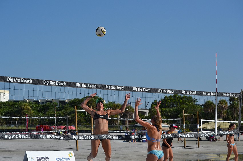 Dana Oliver prepares to spike the ball over Nina Pelliterri.