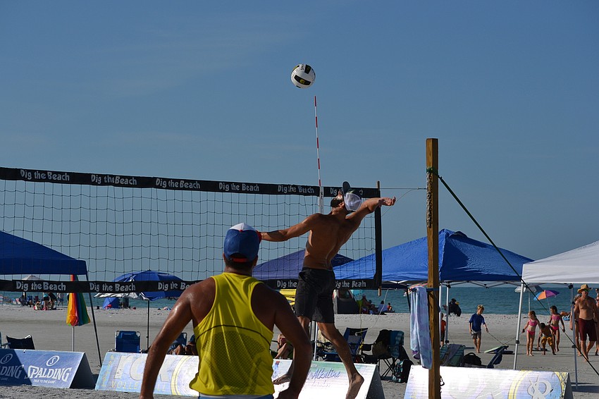 Diogo Sousa spikes the volleyball over the net.