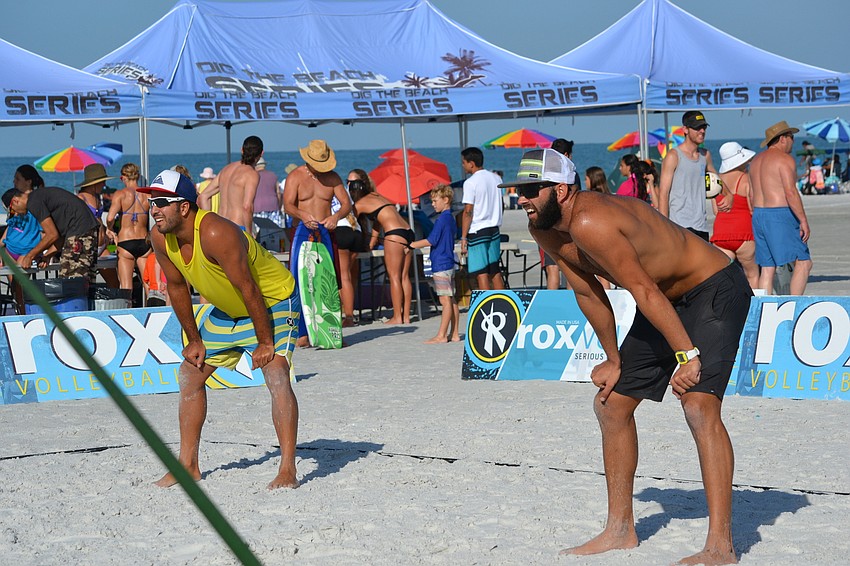 Teammates Yamil Yanes and Diogo Sousa prepare for their opponents to serve the volleyball.