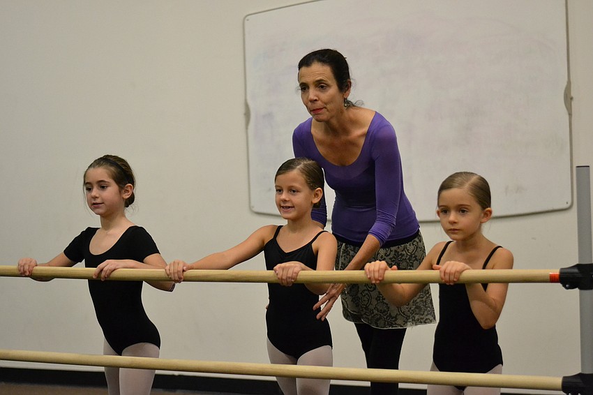 Wendy Johnson instructs students during warm ups.