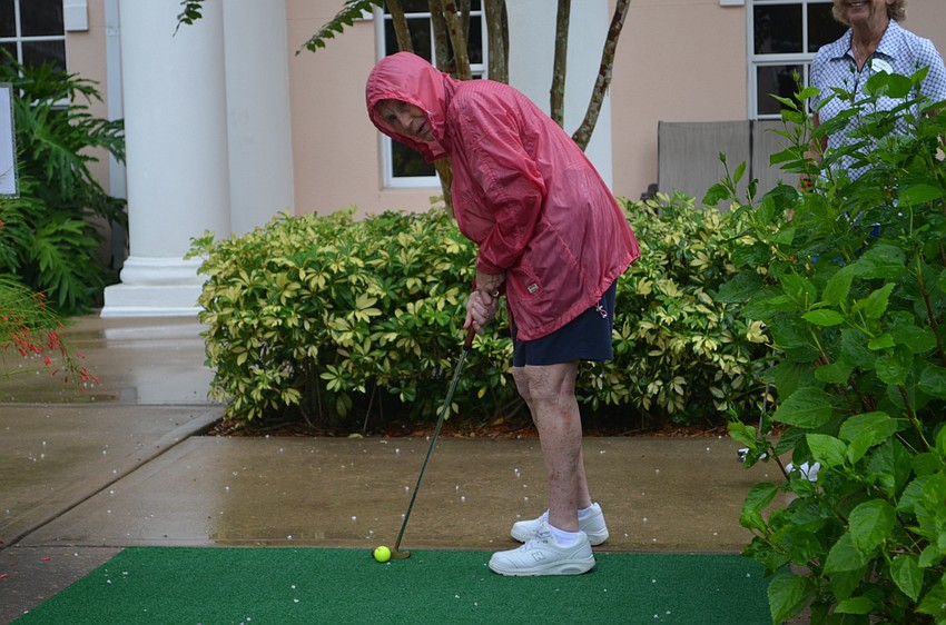Ginny Tarika sets up her shot at the 7th hole.