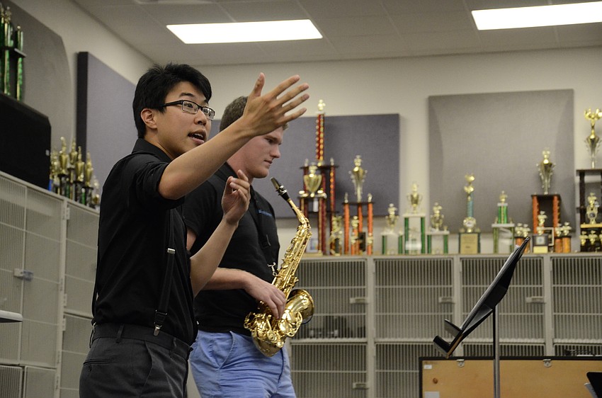 David Cook, fourth clarinetist with the Wichita Symphony Orchestra, asks the audience about the difference in Jeffrey Thompson's sound after adjusting his technique.