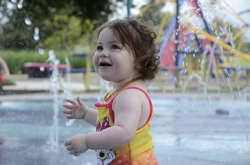 Sasha Leopold, 1 and a half, has her first experience with a splash pad.