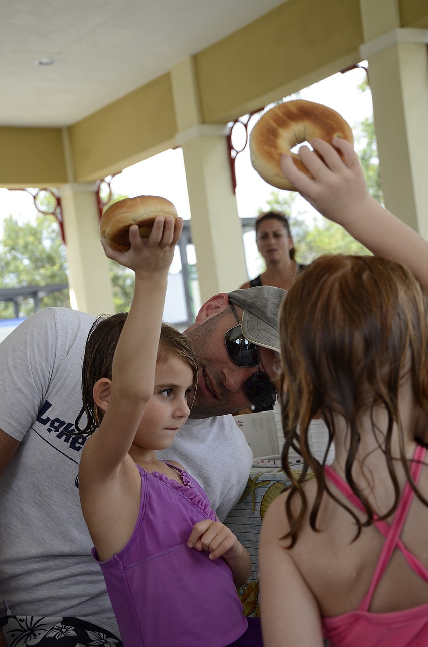Joey Korenman helps his daughters Layla, 4, and Emeline, 3, sing Hamotzi, a blessing usually said before a meal.