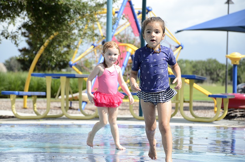 Emeline Korenman, 3, left, and Stella Guido, 4, right, beat the summer heat in the water.