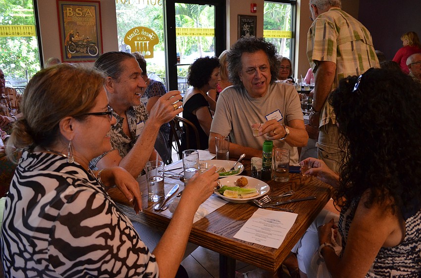 Members of the congregation toast to one another.