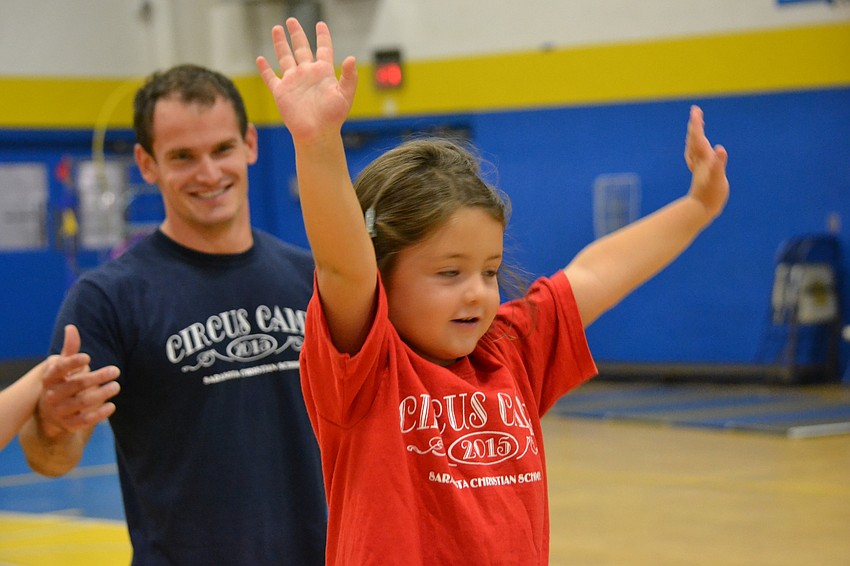 Sofia Karbib throws up her hands after completing the tightrope.
