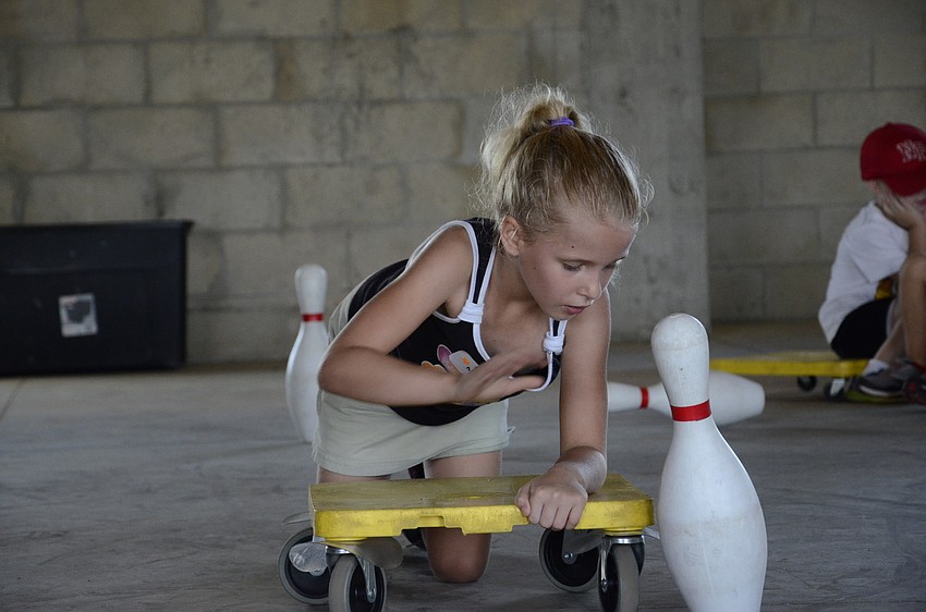 Madison McCaffery sets a pin back up.