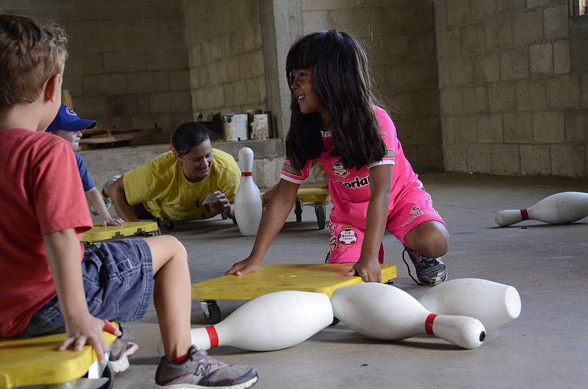 Grace Mendoza knocks over a pin during a game.
