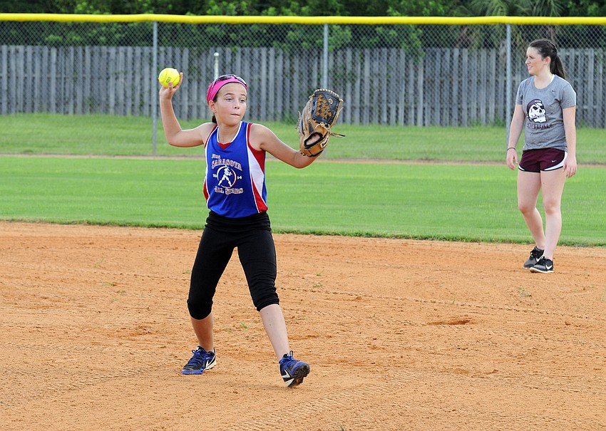 Madyson Hiser, 12, practices her fielding.