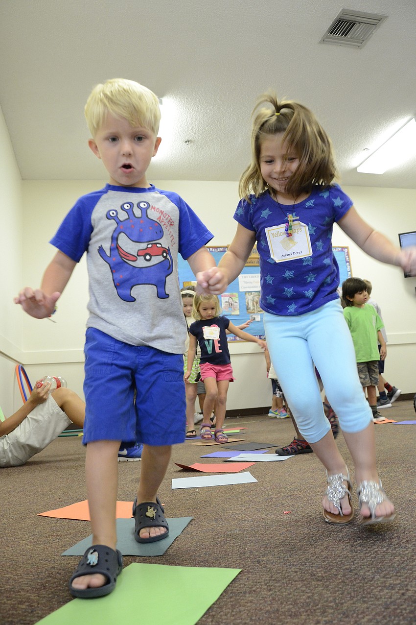 Trey Griffin and Aviana Perez run across their 