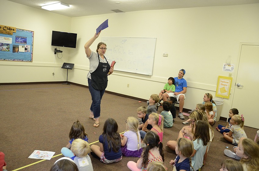 Shannon Satira gets the children's attention to tell them about the bridge game.