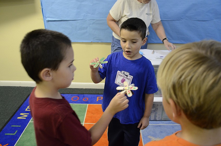 Seth Hayden and Brennan Perra play with their paperclip dragonflies.