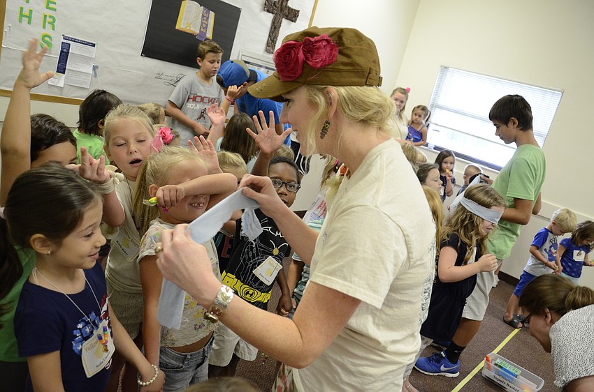 Jennifer Freeman helps blindfold Sofia Llambes for a guide game.