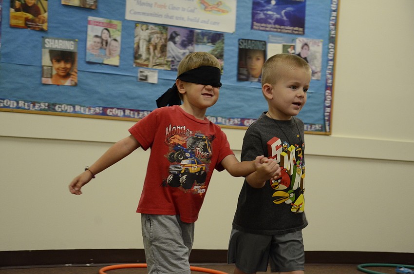 Lucas Burnell, right, leads Jack Kerzner back to the relay line.