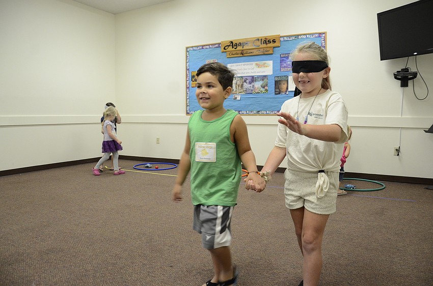 Ezra DeJesus guides Brielle Baker for a game.