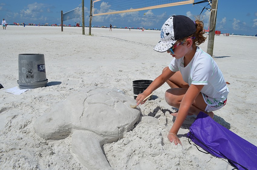 Julia Norman makes the final touches on her sea turtle.