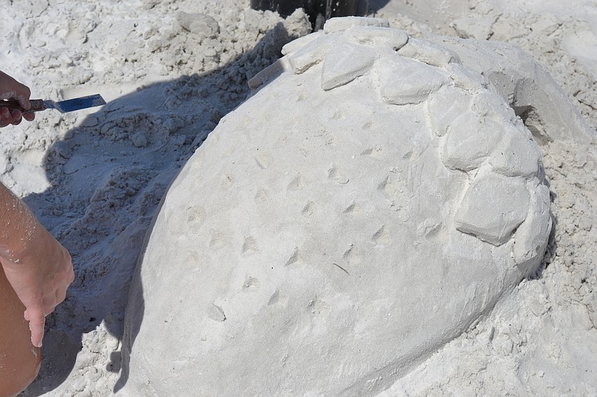 A strawberry sculpted out of sand.