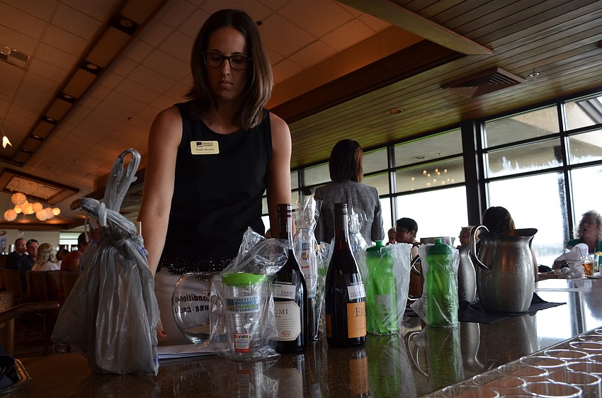 Director of Member Relations for the Greater Sarasota Chamber of Commerce Sarah Murphy organizes door prizes for the luncheon.