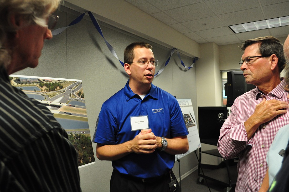 Kevin Ingle, major reconstruction design engineer for FDOT District 1, answers questions from attendees as they view maps of the project July 23.