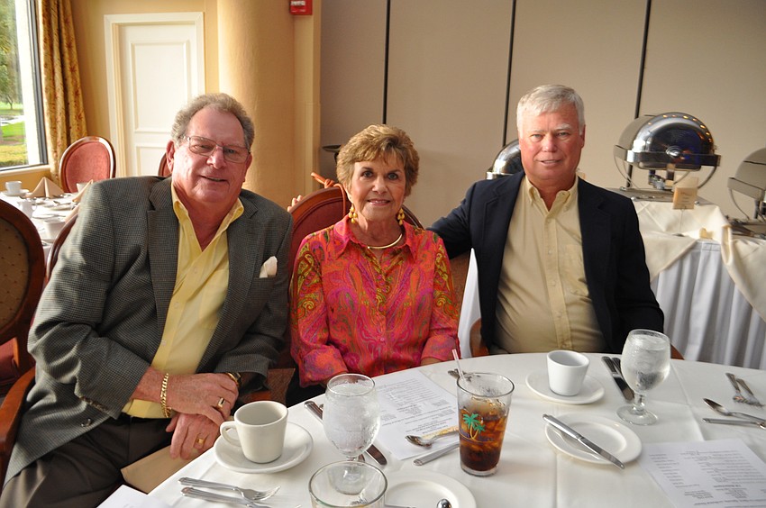 Jim and Jeannine Lyons and Don Moreau catch up.