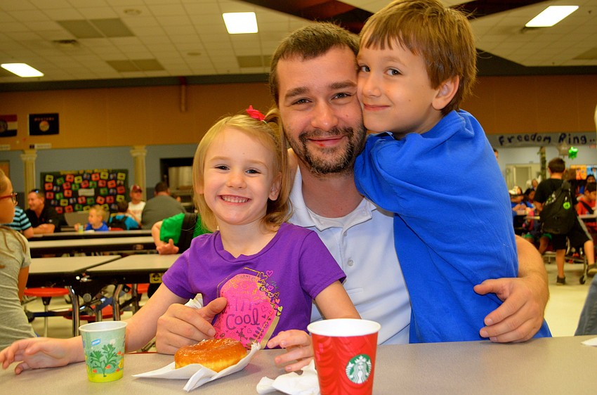 Brian Duke smiles flanked by his two children, Alaina and Jonathan.