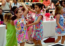 Olivia Vafeas and Claire Steiner dance before the fashion show.