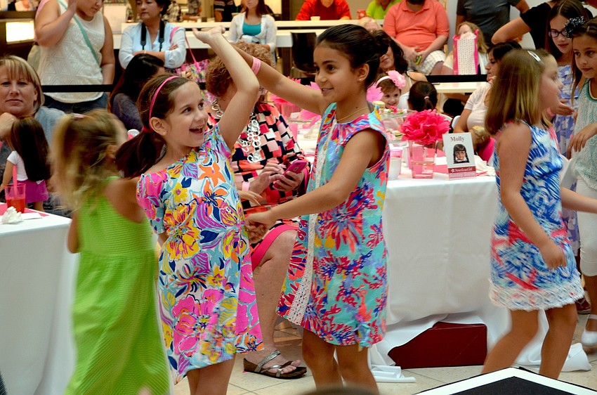 Olivia Vafeas and Claire Steiner dance before the fashion show.