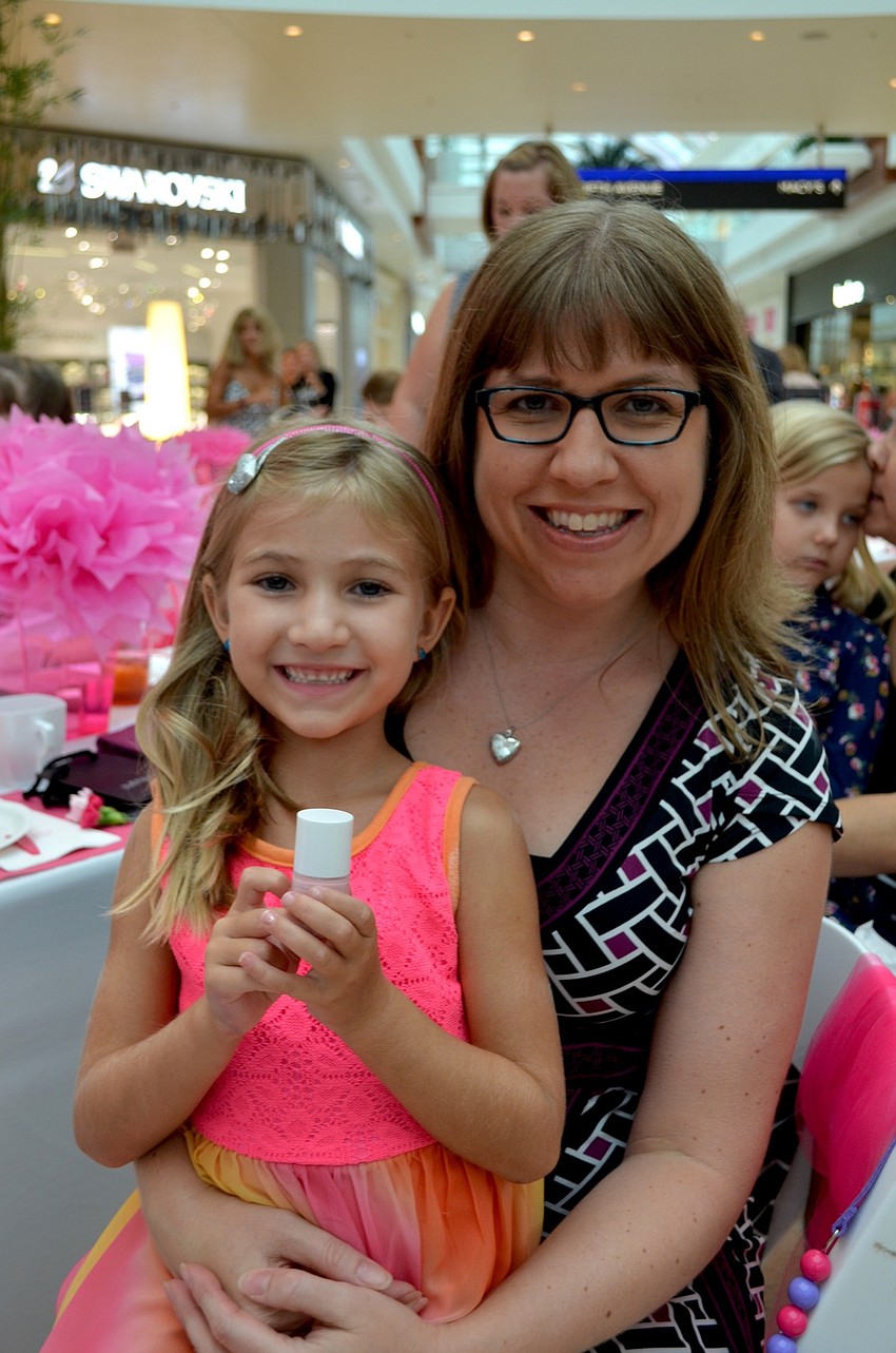 Lauren and Sarah Keck show off the pink nail polish and other loot they received in the swag bag.
