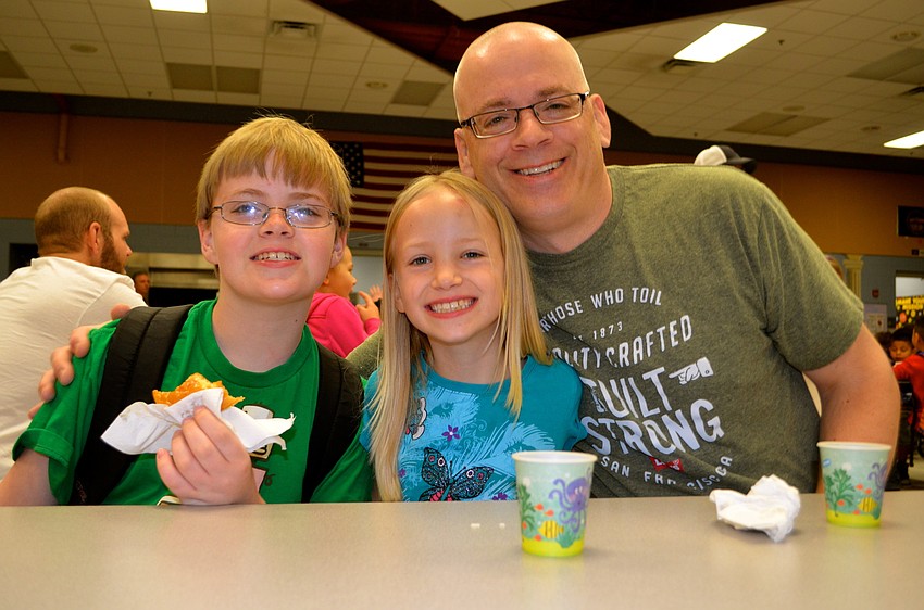Foster Matuszewski says cheese with his sister, Ginger, and father, Brian.