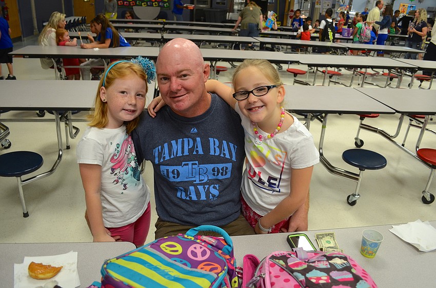 Abby Pollard enjoys talking and donut time with Matt and Sophia Eastman.