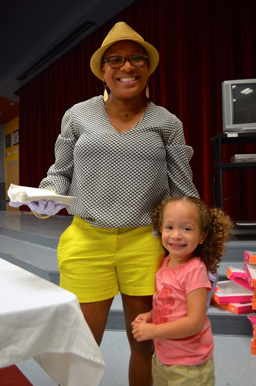 Donnesha Voshell serves up morning sweetness beside her daughter, Ashley.