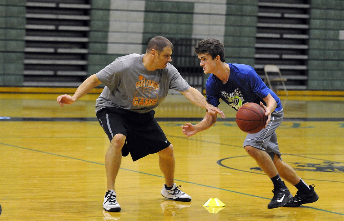 Toby Madison works with Lakewood Ranch freshman Matthew Dugan on ball handling during a private lesson.