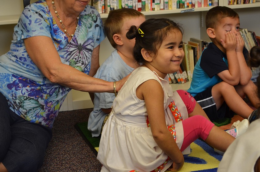 Amani Satia reacts during story time.