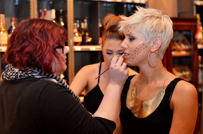 Ashley Pawelczyn applies tribal inspired makeup to model Niki Baldun