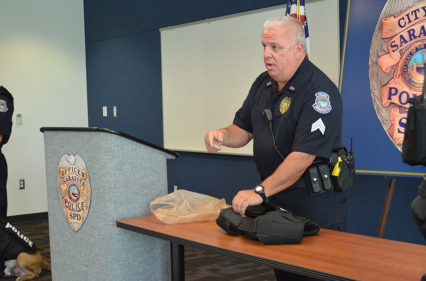 Sarasota Police Sgt. Michael McHale presents one of the vests donated to the K-9 unit.