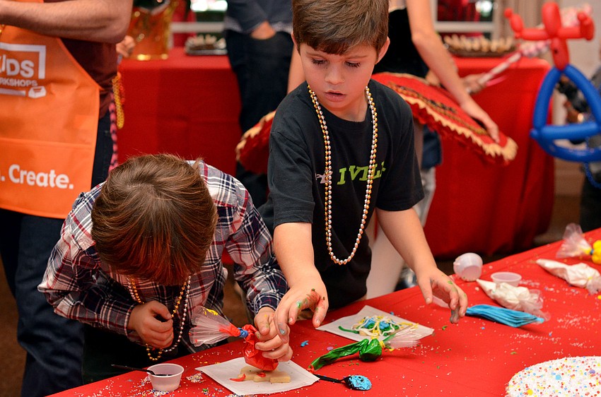 Colt Chalmers and Dylan Recanatesi decorate Christmas cookie at Christmas in Candyland.