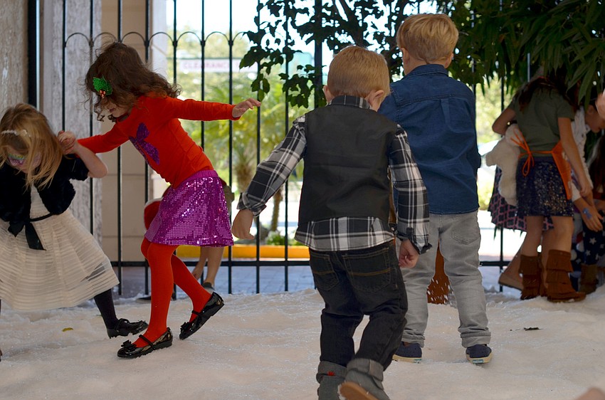 Children play in the snow at Christmas in Candyland.