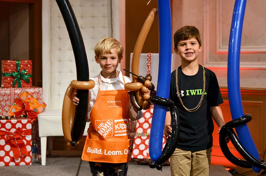 Hugh Rienhoff and Dylan Recantesi sword fight with their balloons.