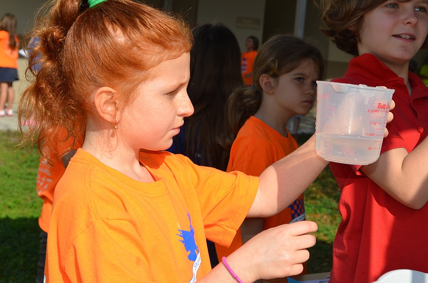 At the sponge squeeze station Meghan Cox looks at how much water came out of her sponge.