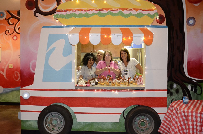 Jessymol Alex, Joan Primeau, Lenda Hammock and Tammy Durst prepare snacks in the food truck.