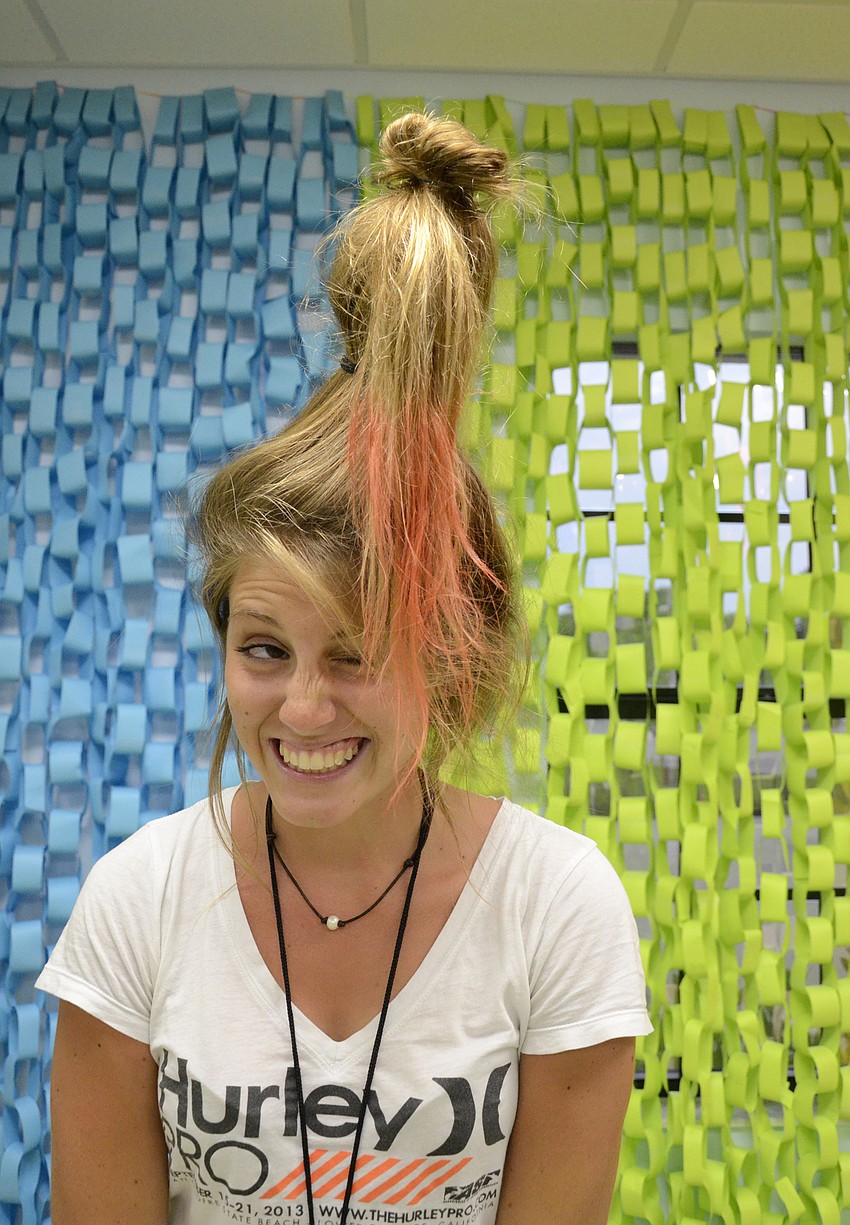 Volunteer Jenna Durst, 16, propped up her hair with a water bottle.