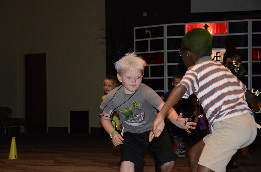 Evan Rowe reaches for a clothespin during a game.