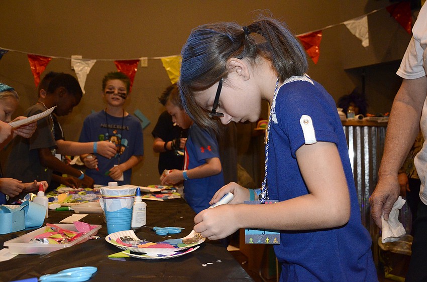Audrey Roden finishes up her paper fish.