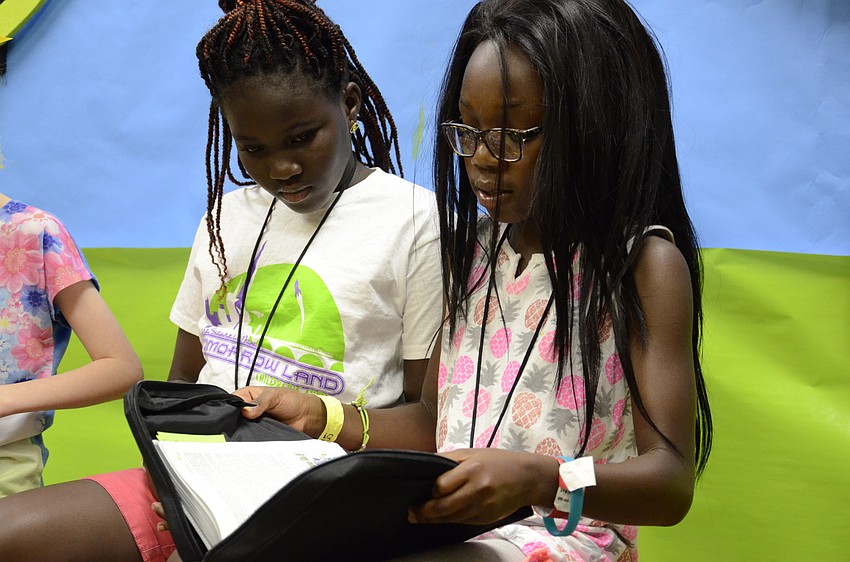 Ewurana Otoo and Amy Kwalhye-Amuah read passages during a class.